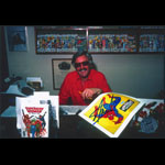 Stan Lee at Desk with Spiderman Poster Autographed Photo